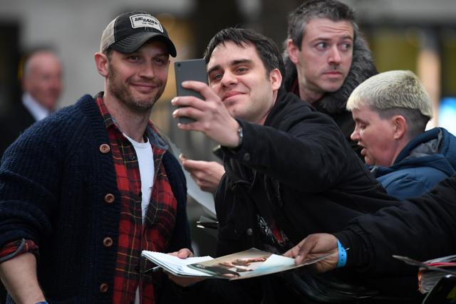British actor Tom Hardy (L) poses for a photograph with a fan. (AFP) British actor Tom Hardy (L) poses for a photograph with a fan. (AFP)