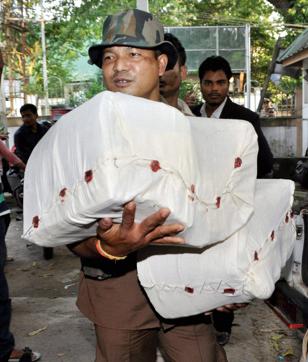 A team of Dibrugarh police seizing the answer scripts of the candidates of Assam Public Service Commission. (PTI) A team of Dibrugarh police seizing the answer scripts of the candidates of Assam Public Service Commission. (PTI)