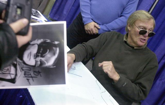In this February 23, 2002 file photo, a fan holds a signed photograph of actor Adam West, right, during the 50th Autorama in Detroit. (AP) In this February 23, 2002 file photo, a fan holds a signed photograph of actor Adam West, right, during the 50th Autorama in Detroit. (AP)