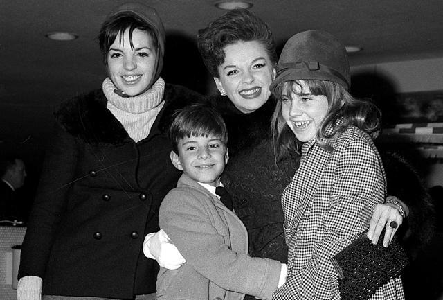Judy Garland greets her son Joseph, 9, and daughter Lorna, 12, after they arrive from California at New York's Kennedy International Airport, in New York. Garland's elder daughter Liza Minnelli poses with them at left. (AP)