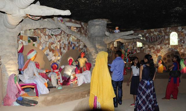 A scene of village men sitting under a tree created using rag dolls. (Keshav Singh/HT Photo)