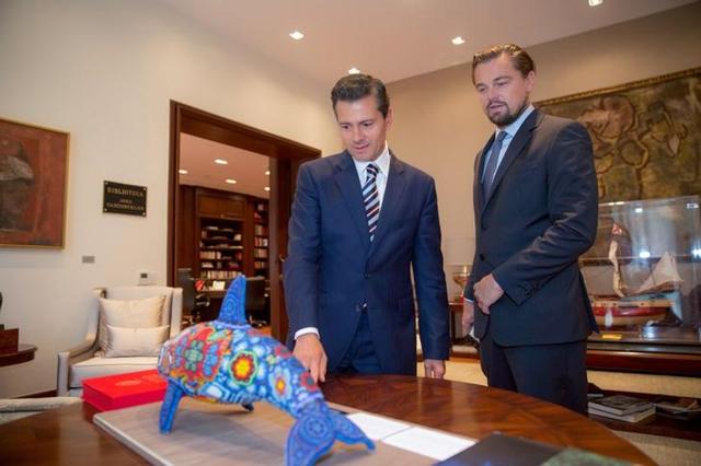 Mexico's President Enrique Pena Nieto gives an indigenous Huichol art representing a Vaquita porpoise to actor Leonardo DiCaprio, at Los Pinos presidential residence in Mexico City. (Reuters)