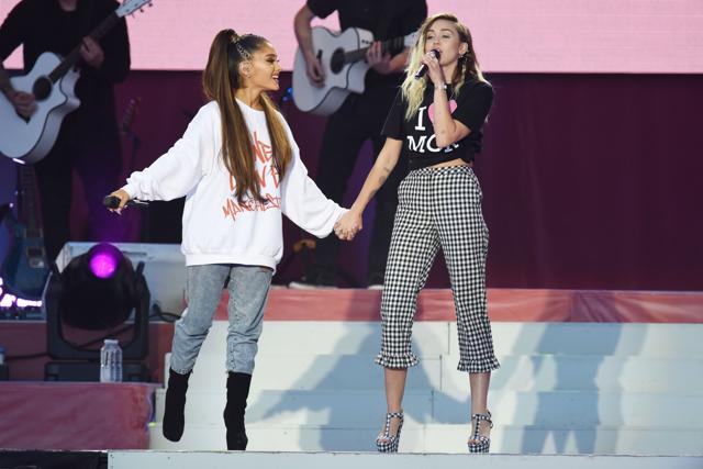 Miley and Ariana performing together at the concert. (AFP)