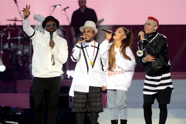 Singers will.i.am, from left, apl.de.ap, Ariana Grande and Taboo perform at the concert. (AP)