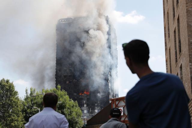 Pedestrians look up towards Grenfell Tower, a residential block of flats in west London. (AFP Photo) Pedestrians look up towards Grenfell Tower, a residential block of flats in west London. (AFP Photo)