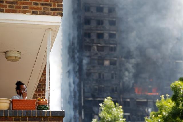 A man covers his face with a cloth as smoke billows from Grenfell Tower. (AFP Photo) A man covers his face with a cloth as smoke billows from Grenfell Tower. (AFP Photo)