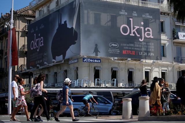 A poster for the Netflix movie Okja, in competition at the Cannes Film Festival, is displayed on the Croisette. (REUTERS) A poster for the Netflix movie Okja, in competition at the Cannes Film Festival, is displayed on the Croisette. (REUTERS)