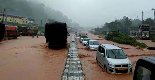 Vehicles wade through water logging National Highway in Guwahati after heavy showers on June 13, 2017. (PTI)