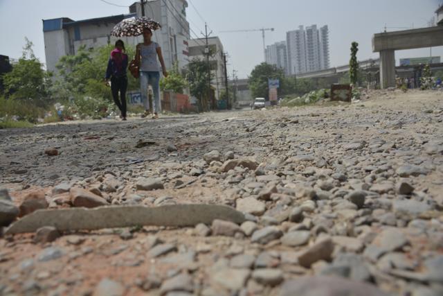 This road in Vasundhra Sector 5 in Ghaziabad has gone missing under the potholes. A budget of Rs 1,400 crore was allotted for work across the state. (Sakib Ali /HT Photo)