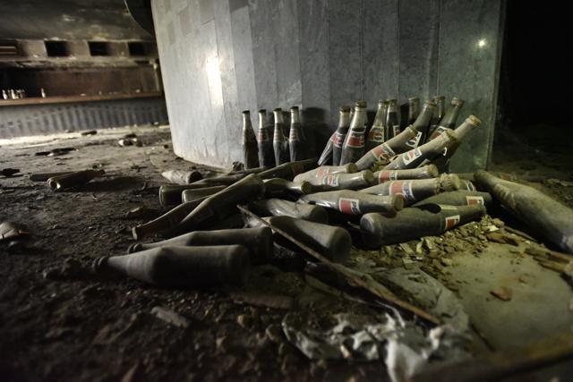 The cinema hall today is littered with shoes, bottles, fire-blackened seats, vehicles and debris from 20 years ago. (Burhaan Kinu/HT PHOTO) The cinema hall today is littered with shoes, bottles, fire-blackened seats, vehicles and debris from 20 years ago. (Burhaan Kinu/HT PHOTO)