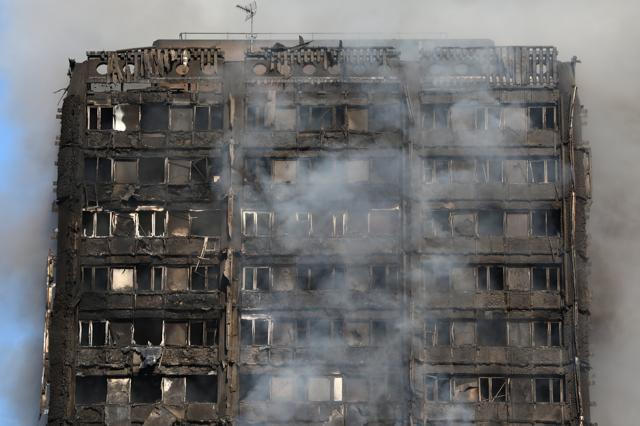 Smoke billows from a tower block damaged by fire, in North Kensington, West London. (Reuters Photo) Smoke billows from a tower block damaged by fire, in North Kensington, West London. (Reuters Photo)