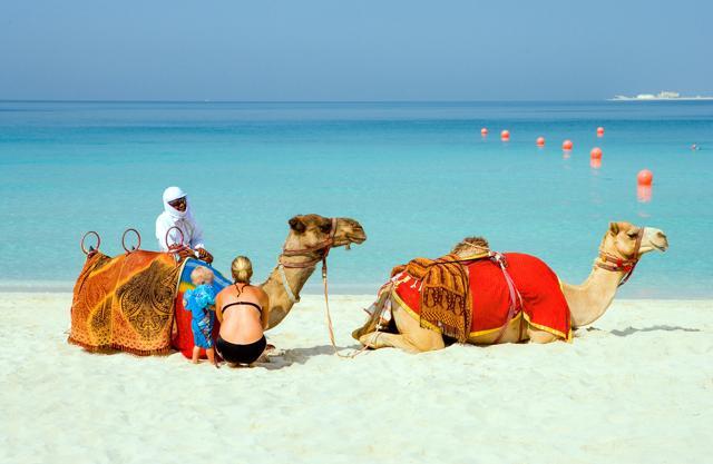 Camels and tourists on the beach of the Oasis Resort in the new Marina quarter. (Shutterstock) Camels and tourists on the beach of the Oasis Resort in the new Marina quarter. (Shutterstock)