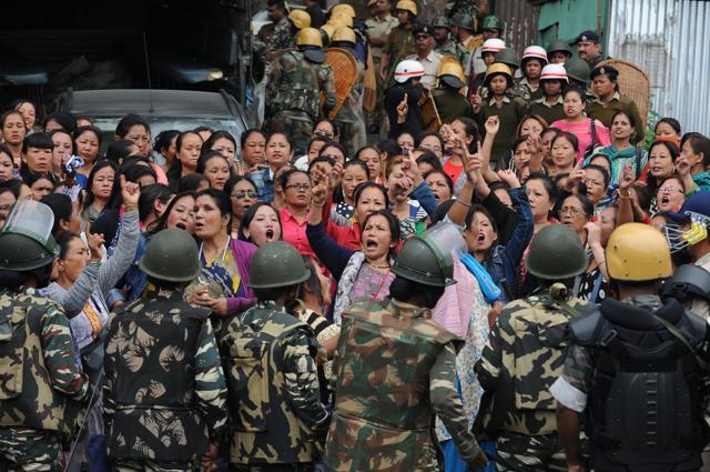 Police personnel stop Gorkha Janmukti Morcha (GJM) supporters following a raid at the GJM office in Darjeeling on June 15, 2017. (AFP)
