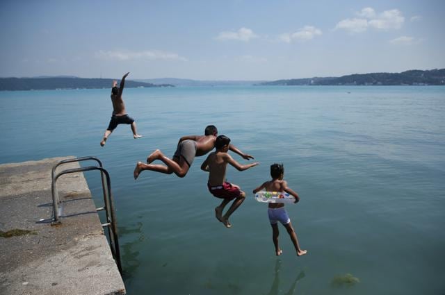 Children jump into the Bosphorus Strait on Wednesday. (AP) Children jump into the Bosphorus Strait on Wednesday. (AP)