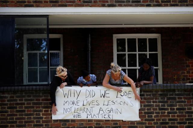Local residents hang a banner over a balcony. (Reuters) Local residents hang a banner over a balcony. (Reuters)