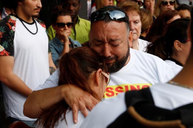 People react near the scene of the fire which destroyed the Grenfell Tower block. (Reuters) People react near the scene of the fire which destroyed the Grenfell Tower block. (Reuters)