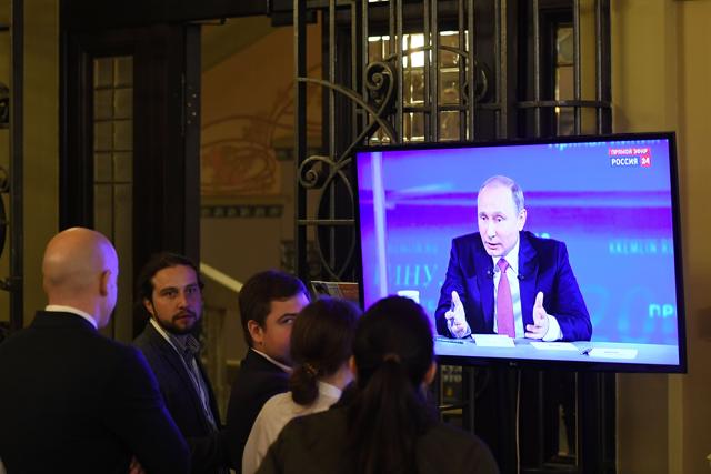 People watch Russian President Vladimir Putin answering questions during the annual Direct Line with Vladimir Putin broadcast live by Russian TV channels in Moscow. (AFP) People watch Russian President Vladimir Putin answering questions during the annual Direct Line with Vladimir Putin broadcast live by Russian TV channels in Moscow. (AFP)