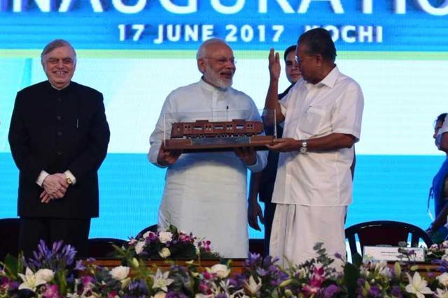 Kerala CM Vijayan presents a hand-carved wooden replica of a metro coach to PM Narendra Modi at the inauguration in Kochi. Considered the fastest completed metro project in the country, Kochi Metro, the flagship transportation infrastructure project of Kerala, will start its regular operations from June 19. (PIB India) Kerala CM Vijayan presents a hand-carved wooden replica of a metro coach to PM Narendra Modi at the inauguration in Kochi. Considered the fastest completed metro project in the country, Kochi Metro, the flagship transportation infrastructure project of Kerala, will start its regular operations from June 19. (PIB India)
