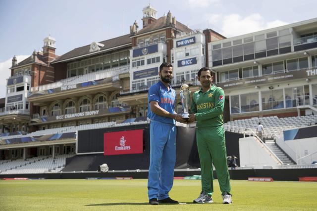 India captain Virat Kohli and Pakistan skipper Sarfraz Ahmed pose with the ICC Champions Trophy at The Oval in London on Saturday. (AP)