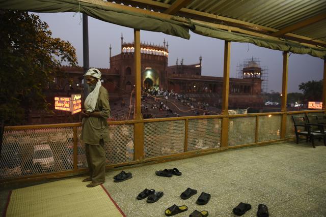 A worker at Haji Hotel offers the Maghrib namaz that immediately follows the breaking of the fast at iftar. (Saumya Khandelwal/HT PHOTO) A worker at Haji Hotel offers the Maghrib namaz that immediately follows the breaking of the fast at iftar. (Saumya Khandelwal/HT PHOTO)