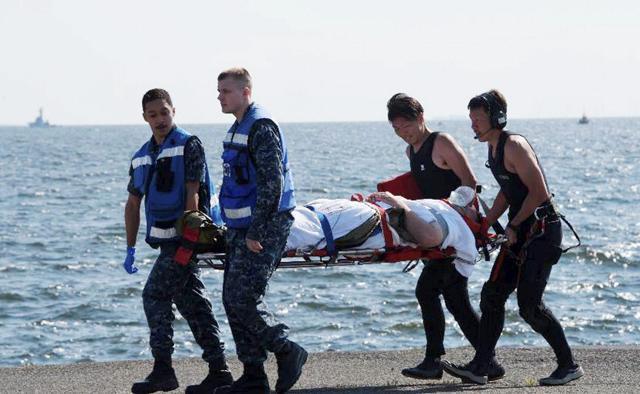 In this photo released by Japan's Defense Ministry, an injured USS Fitzgerald personnel is carried by US military personnel and Japanese Maritime Self-Defense Force members. (AP Photo) In this photo released by Japan's Defense Ministry, an injured USS Fitzgerald personnel is carried by US military personnel and Japanese Maritime Self-Defense Force members. (AP Photo)