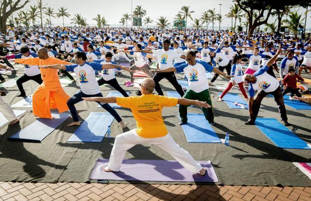Hundreds of people take part in a yoga session at the amphitheatre lawns at North Beach on June 18 in Durban, South Africa, ahead of the International Day of Yoga on June 21, 2017. (AFP)