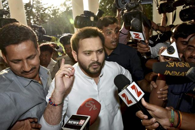 Bihar deputy chief minister Tejashwi Yadav speaks to the media at the old secretariat in Patna on Tuesday. The Income Tax department on Tuesday carried out raids at various locations in Delhi-NCR on companies and people associated with RJD chief Lalu Prasad in connection with the benami land deals worth Rs 1,000 crore. (PTI) Bihar deputy chief minister Tejashwi Yadav speaks to the media at the old secretariat in Patna on Tuesday. The Income Tax department on Tuesday carried out raids at various locations in Delhi-NCR on companies and people associated with RJD chief Lalu Prasad in connection with the benami land deals worth Rs 1,000 crore. (PTI)