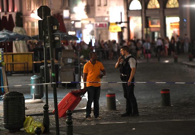 A police official (R) guides a member of the public on a street outside Gare Centrale in Brussels on June 20, 2017, after an explosion in the Belgian capital. (AFP) A police official (R) guides a member of the public on a street outside Gare Centrale in Brussels on June 20, 2017, after an explosion in the Belgian capital. (AFP)
