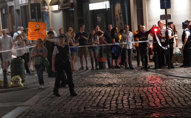 A police official guides a member of the public as others stand behind a taped off area on a street outside Gare Centrale in Brussels on June 20. (AFP Photo) A police official guides a member of the public as others stand behind a taped off area on a street outside Gare Centrale in Brussels on June 20. (AFP Photo)