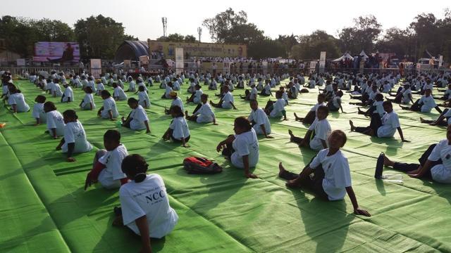 Participants perform yoga at Lal Parade Ground in Bhopal. (Mujeeb Faruqui/HT Photo)