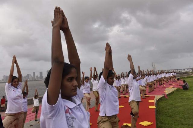 A group of women practice yoga near Bandra reclamation. (Satish Bate/HT Photo)