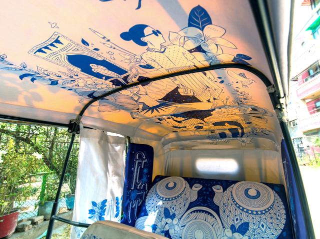 An auto rickshaw that has interiors done in the theme of Dilli Haat. An auto rickshaw that has interiors done in the theme of Dilli Haat.