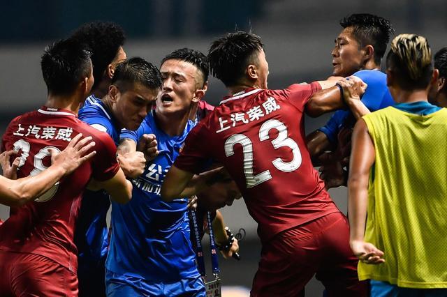 The photo shows the brawl erupting between Shanghai SIPG (in red) and Guangzhou R&F (in blue) during their Chinese Super League match in Guangzhou. Oscar triggered the mass brawl as players and staff from both the teams scrapped on the pitch. (AFP) The photo shows the brawl erupting between Shanghai SIPG (in red) and Guangzhou R&F (in blue) during their Chinese Super League match in Guangzhou. Oscar triggered the mass brawl as players and staff from both the teams scrapped on the pitch. (AFP)