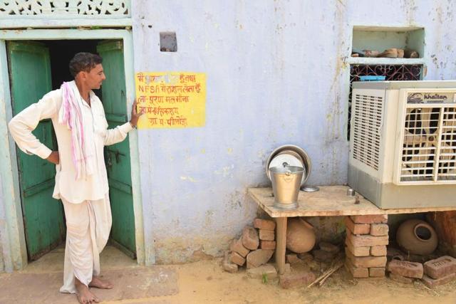 A man stands near the official writing on the wall outside his home at Pilodi in Dausa. (Prabhakar Sharma / HT Photo) A man stands near the official writing on the wall outside his home at Pilodi in Dausa. (Prabhakar Sharma / HT Photo)
