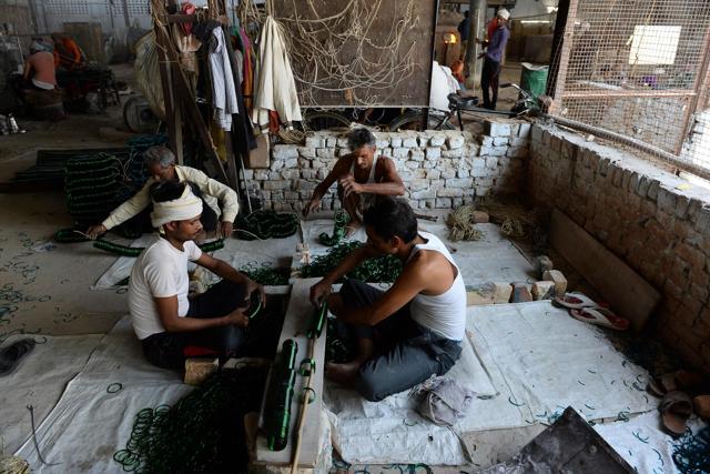 Workers use razors to cut glass bangles at a factory in Firozabad. (AFP Photo) Workers use razors to cut glass bangles at a factory in Firozabad. (AFP Photo)
