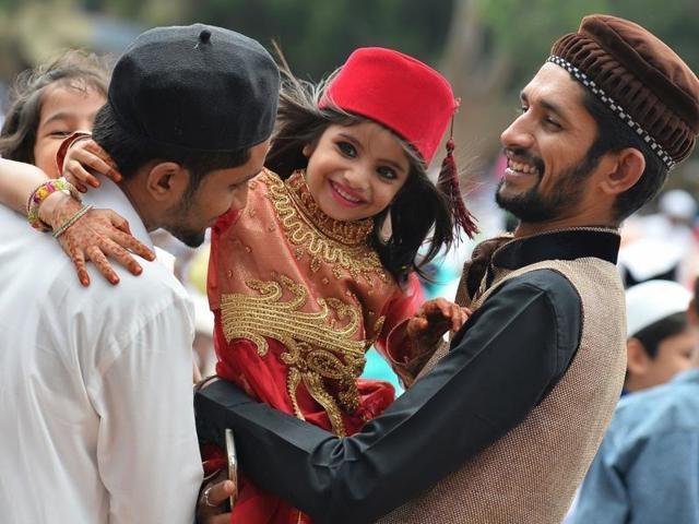 A young girl hugs her elders after Eid-al-Fitr prayers at Chamrajpet Idgah Maidan in Bangalore. (Manjunath Kiran/AFP File Photo) A young girl hugs her elders after Eid-al-Fitr prayers at Chamrajpet Idgah Maidan in Bangalore. (Manjunath Kiran/AFP File Photo)