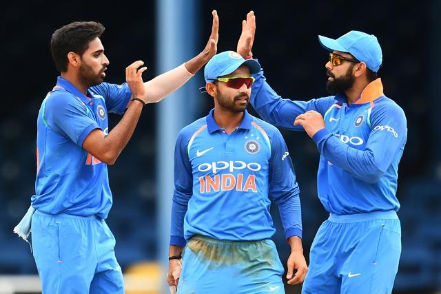 India's Bhuvneshwar Kumar (L) celebrates with teammate Ajinkya Rahane (C) and captain Virat Kohli. (AFP)