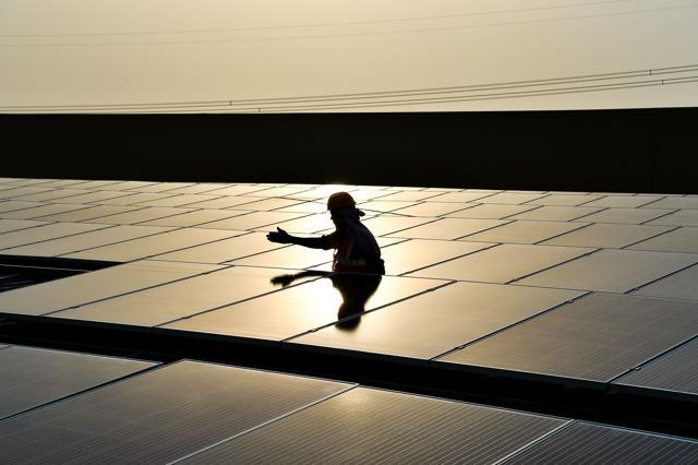 In this May 16, 2017, photograph, a labourer installs solar panels at a site in Greater Noida, some 45km from New Delhi. Solar power prices in India have hit rock bottom, but it is not all good news for the electricity-starved country as the phenomenon has hit investor confidence and threatens the country's effort to push its green credentials. (AFP file photo) In this May 16, 2017, photograph, a labourer installs solar panels at a site in Greater Noida, some 45km from New Delhi. Solar power prices in India have hit rock bottom, but it is not all good news for the electricity-starved country as the phenomenon has hit investor confidence and threatens the country's effort to push its green credentials. (AFP file photo)