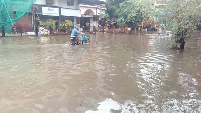 A man wades through a waterlogged street in Sion. (Kunal Patil/HT) A man wades through a waterlogged street in Sion. (Kunal Patil/HT)