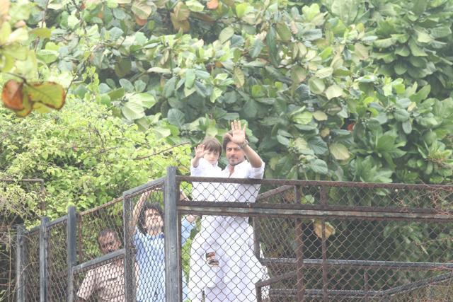 Shah Rukh Khan along with his son AbRam geets his fans on the occasion of Eid-ul-Fitr at his residence. (IANS)