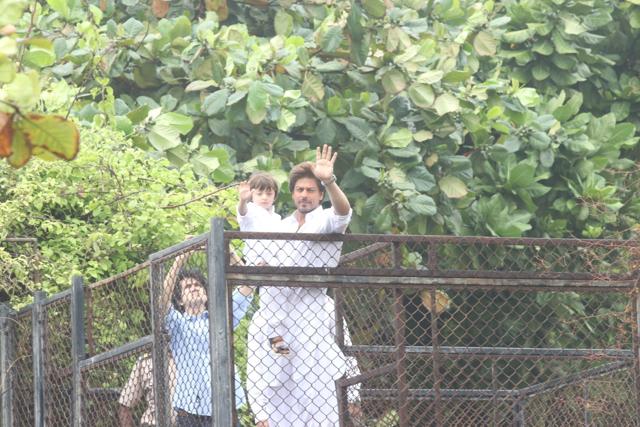 Shah Rukh Khan along with his son AbRam greets his fans on the occasion of Eid-ul-Fitr at his residence in Mumbai. (IANS) Shah Rukh Khan along with his son AbRam greets his fans on the occasion of Eid-ul-Fitr at his residence in Mumbai. (IANS)