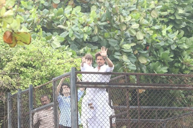 Shah Rukh Khan along with his son AbRam geets his fans on the occasion of Eid-ul-Fitr at his residence in Mumbai. (IANS)