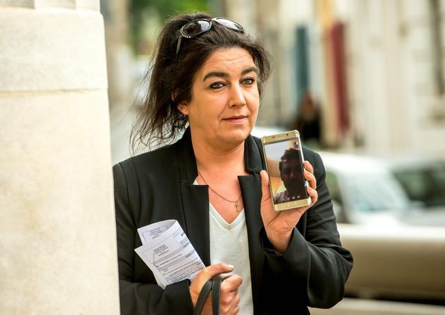 Beatrice Huret calls Mokhtar, a migrant from Iran she helped to reach Great Britain, as she arrives at Boulogne-sur-Mer court house. (AFP Photo) Beatrice Huret calls Mokhtar, a migrant from Iran she helped to reach Great Britain, as she arrives at Boulogne-sur-Mer court house. (AFP Photo)