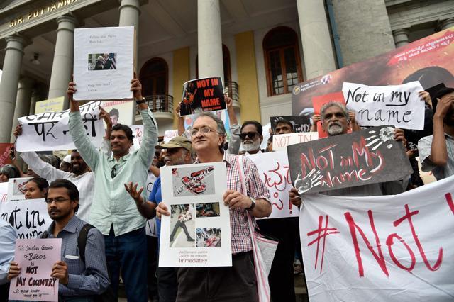 Noted historian and writer Ramchandra Guha along with other citizens holds placards during a silent protest in Bengaluru on Wednesday. (PTI) Noted historian and writer Ramchandra Guha along with other citizens holds placards during a silent protest in Bengaluru on Wednesday. (PTI)