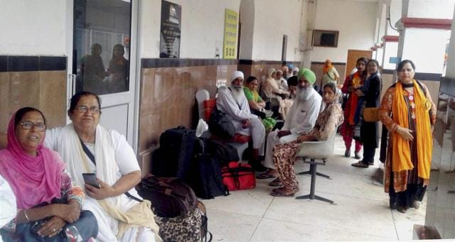 Sikh devotees wait for a special train at the Attari International railway station for travelling to Pakistan. (PTI)