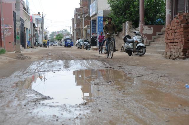 Rains mean slush in Nayagaon in the absence of drains or bitumen roads. (Keshav Singh/HT)
