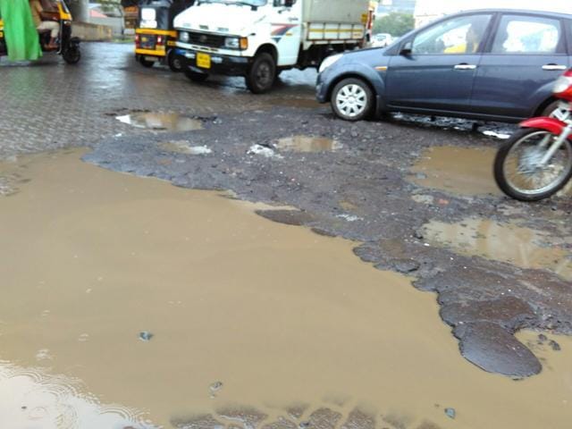Numerous potholes surfaced on the Thane-Belapur Road under the Turbhe flyover. (Bachchan Kumar) Numerous potholes surfaced on the Thane-Belapur Road under the Turbhe flyover. (Bachchan Kumar)