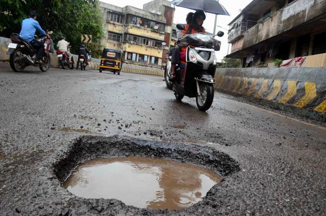 A 50-year-old man was hurt after he fell off his bike, which skidded owing to this pothole on Anand Dighe bridge in Kalyan. (Rishikesh Choudhary) A 50-year-old man was hurt after he fell off his bike, which skidded owing to this pothole on Anand Dighe bridge in Kalyan. (Rishikesh Choudhary)