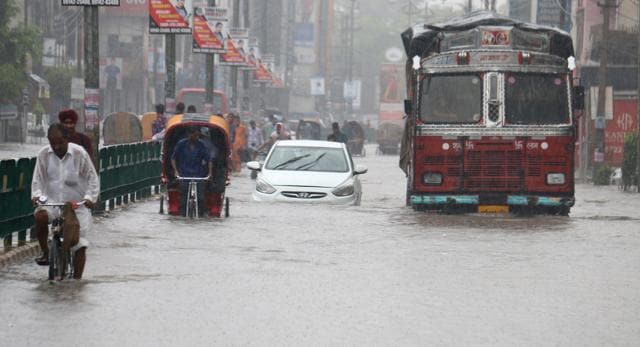 Commuters make their way through a road filled with water on Mall Road in Bathinda on Thursday. (Sanjeev Kumar/HT) Commuters make their way through a road filled with water on Mall Road in Bathinda on Thursday. (Sanjeev Kumar/HT)