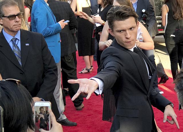 Tom Holland poses for a photo as he arrives at the Los Angeles premiere of Spider-Man: Homecoming at the TCL Chinese Theatre. (Paula Munoz/Invision/AP) Tom Holland poses for a photo as he arrives at the Los Angeles premiere of Spider-Man: Homecoming at the TCL Chinese Theatre. (Paula Munoz/Invision/AP)